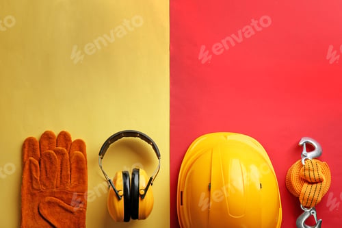 Preview: Flat lay composition with safety equipment and space for text on color background
