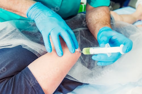 Preview: Neurologist doctor makes an injection therapy (blockade) into elbow joint muscle of male patient.