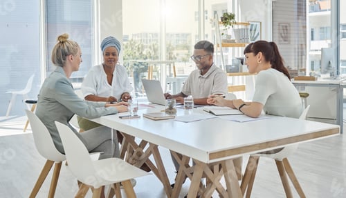 Preview: Cropped shot of a group of young diverse businesspeople having a meeting in the boardroom