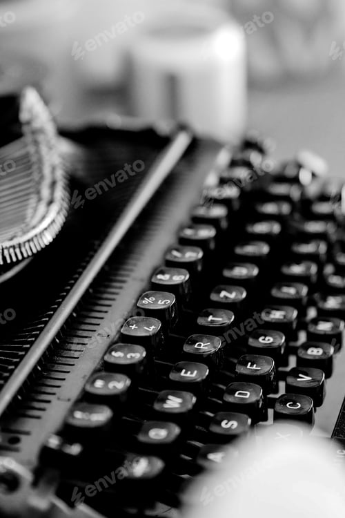 Preview: Grayscale closeup shot of an old vintage typewriter with blurred background
