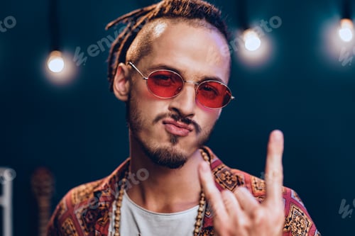 Preview: Stylish guy with dreadlocks wearing pink sunglasses