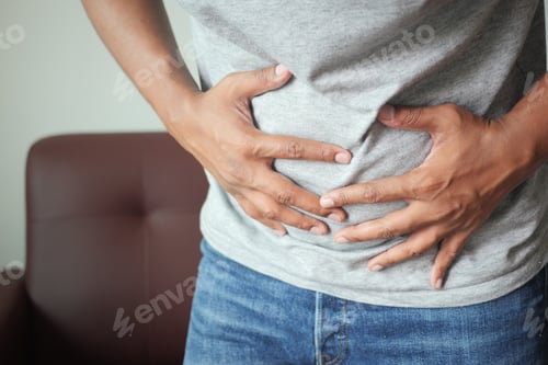 Preview: young man suffering stomach pain close up.