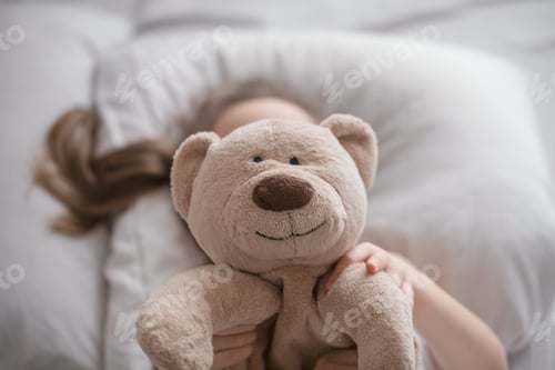 Preview: Little cute girl in bed with toy