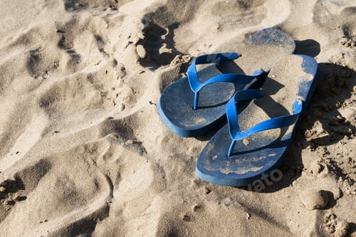 Preview: Blue Flip Flops on Sandy Beach Shoreline