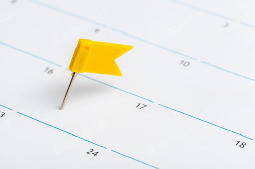 Preview: Sticky notes mark important dates on a calendar with a yellow flag on the 17th