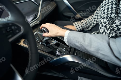 Preview: Female hand in business jacket on gear box