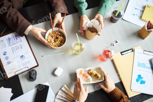 Preview: Young Asian Businessmen and Businesswomen Collaborating during Office Lunch