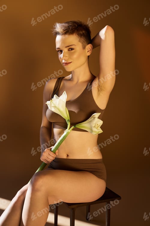 Preview: Embracing beauty and confidence with flowers and soft lighting in a warm setting