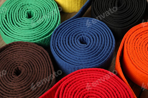 Preview: Colorful karate belts, closeup. Martial arts uniform