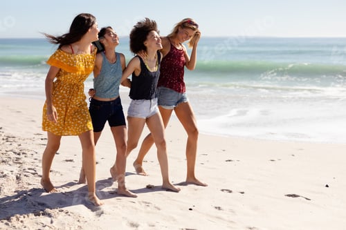 Preview: Multi-ethnic group of female standing on the beach