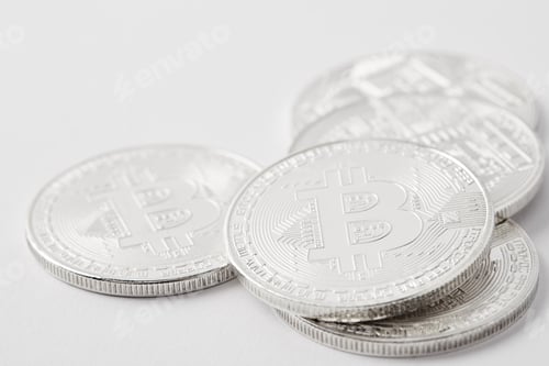 Preview: close-up shot of heap of bitcoins lying on white surface