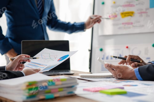 Preview: Businessman is reviewing monthly sales documents for analysis and marketing plans for more sales gro