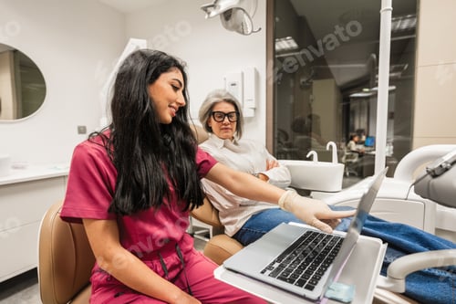 Preview: Dentist explaining dental treatment to senior patient