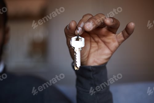 Preview: African black man holding home keys in hand
