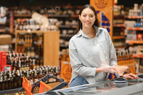 Preview: woman with a shopping bag as a customer buying fish at the refrigerated shelf in the supermarket