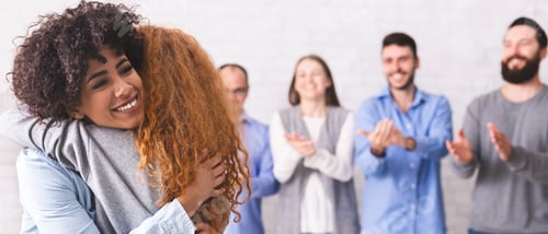 Preview: Cheerful people hugging during group therapy session