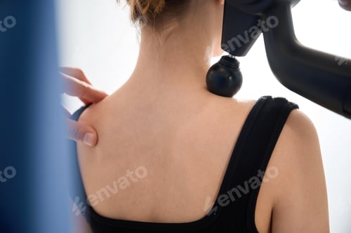 Preview: Physiotherapist massages a patient's back with a special massager