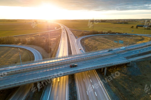 Preview: Aerial view of modern highway road intersection at dawn on rural landscape