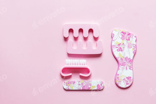 Preview: Flat lay of set for pedicure on pink background with copy space