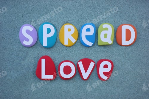 Preview: Spread love, social slogan composed with hand painted multi colored stone letters over green sand