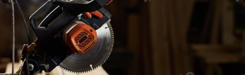 Preview: a miter saw in a rustic workshop filled with wood