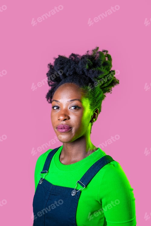 Preview: Studio portrait young black woman looking camera smiling isolated pink background