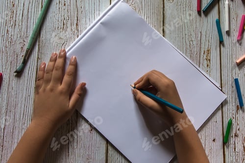 Preview: Hands of a boy holding a pencil