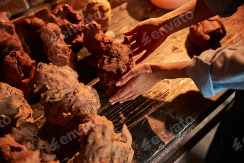 Preview: Unrecognized female ceramicist modeling something in art cozy workshop