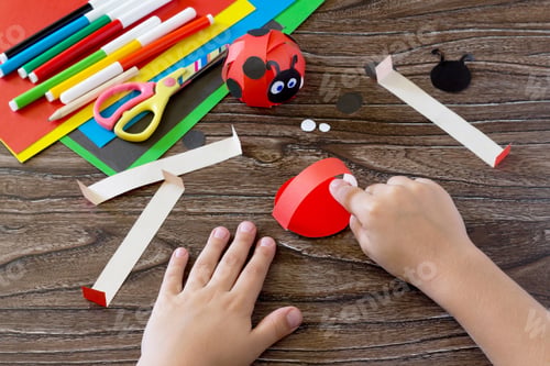 Preview: The child makes crafts out of paper ladybug.