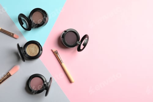 Preview: Flat lay composition with different eye shadows on color background. Space for text