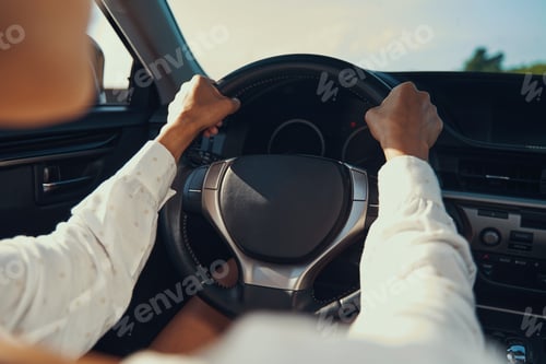 Preview: Hand on steering wheel of expensive car
