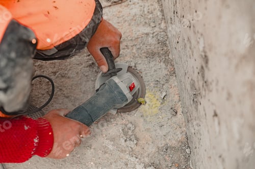 Preview: View of a worker at a construction site working with a rock-drill and digging the ground