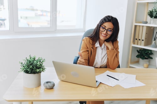 Preview: Business woman working in the office at her desk with a laptop, smile and business dialogue via