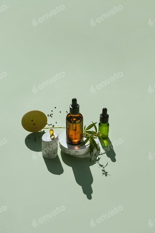Preview: Various glass bottles with CBD oil and tincture and capsule on podiums