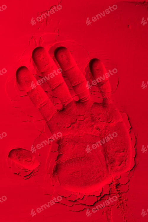 Preview: top view of human hand shape on red powder