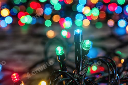 Preview: Beautiful bright Christmas lights on table, closeup