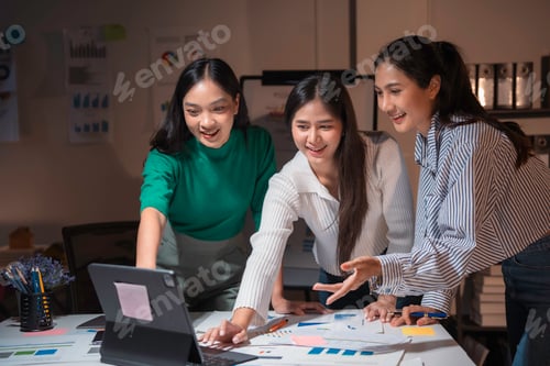 Preview: Three asian businesswomen working together using a tablet