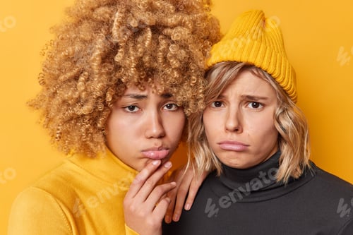 Preview: Two frustrated young cute women feel unhappy look gloomy and ispleased upset because of problem dres