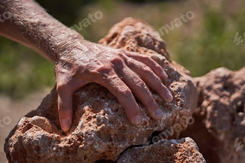 Preview: Crop man leaning on stone