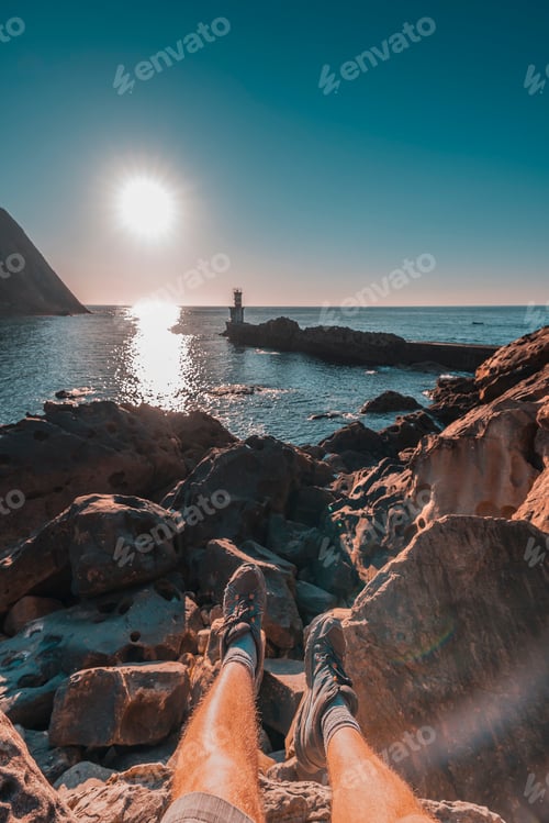Preview: Feet of a young man sitting at the Lighthouse in Pasajes San Juan near San Sebastian