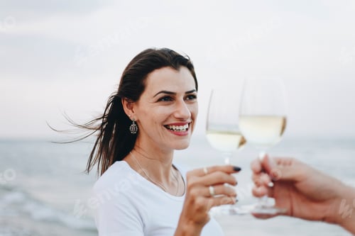 Preview: Couple enjoying a glass of wine by the beach