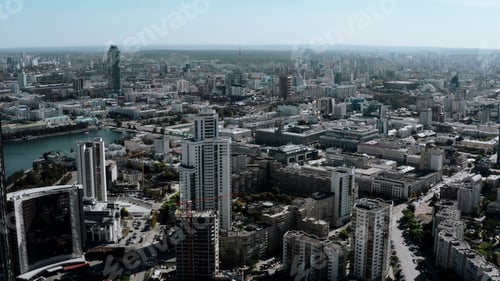 Preview: Helicopter view of the built-up summer city. Stock footage. Sunny view of the city center with