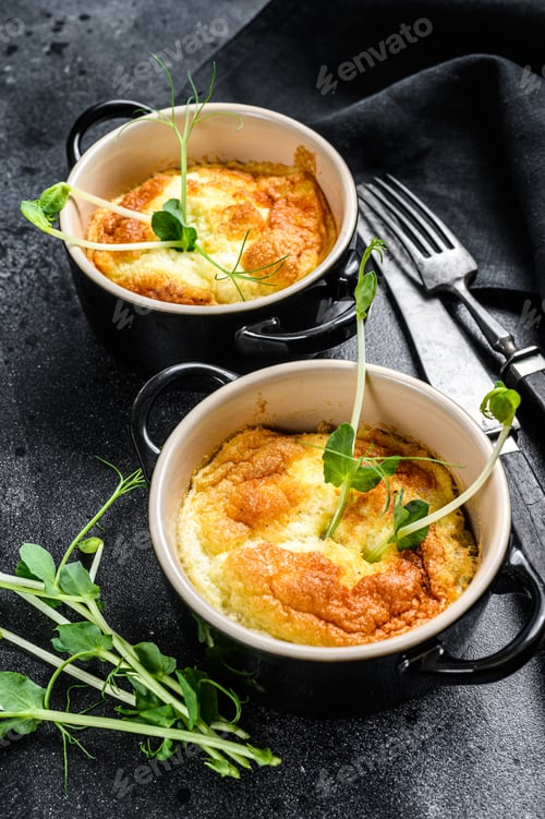 Preview: Cheese omelette , omelet with microgreens in a pan. Black background. Top view