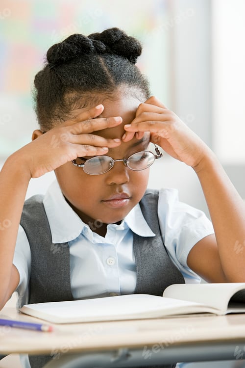 Preview: Young student concentrating on homework with a focused expression.