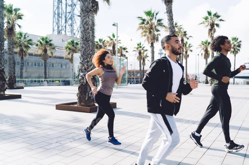 Preview: Experienced runners in sportive wear enjoying morning cardio exercising during crossfit practice