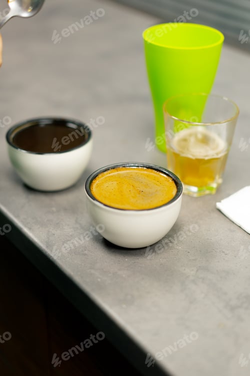 Preview: close-up coffee roasting factory in the kitchen, a bowl of coffee is collected with spoons of foam