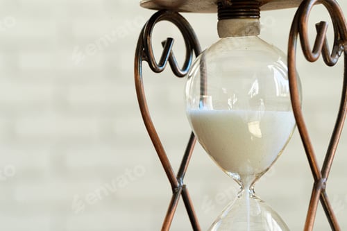 Preview: Sandglass on wooden bakground closeup. Time concept