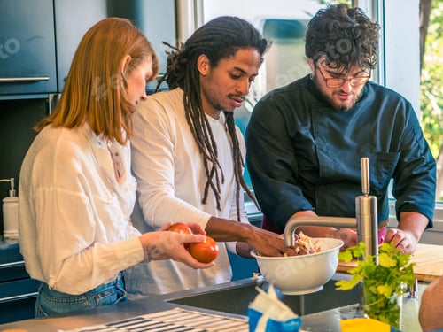 Preview: Interracial couple prepare food together with a professional chef.