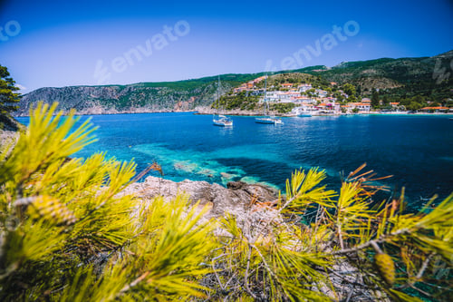 Preview: Amazing Assos village, Kefalonia. Greece. White cruise yachts staying at anchor in beautiful emerald