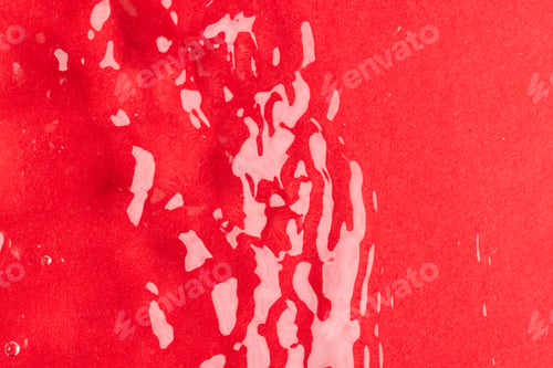 Preview: Close up of water ripples and waves with copy space on red background